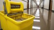 © Nataly - Close-up of a janitor's mop bucket on a wet floor. Professional cleaning of a long institutional hallway