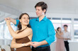 © JackF - Couple of young guy and young woman dancing waltz in studio