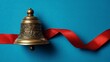 © sablengjago - Close-up of a bronze bell with detailed engravings, resting on a striking blue surface, red ribbon weaving around
