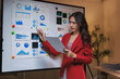 © Phimwilai - Woman presenting business data on whiteboard in office