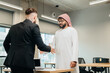 © dsheremeta - Businessmen shaking hands in modern office space