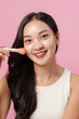 © Natee Meepian - Makeup Application. Smiling woman applying blush with brush for radiant look.