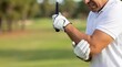 © Volha - Man experiencing elbow pain playing golf on course