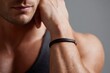 © Nang - A close-up of a Caucasian man's forearm wearing a sleek leather bracelet, skin fair and smooth