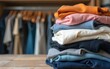 © Liam - Stack of second hand clothes with used wardrobe for reuse and empty craft card. Circular fashion, fast fashion, Sustainable ethical consumption and shopping, donation, thrifting shop concept