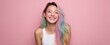 © Andrii Zastrozhnov - Smiling young asian female with pastel rainbow hair against pink background