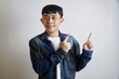 © yashis007 - Cheerful Young Man Pointing Sideways with a Smile, Expressing Enthusiasm on White Background