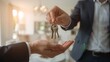 © Asawin - a pair of hands exchanging keys, symbolizing home ownership or property transfer, with the keys are being handed over from one person to another