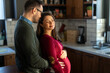 © NDABCREATIVITY - Man in love hugs his pregnant wife, they are waiting together for the baby's arrival. Love, family