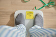 © rjankovsky - Person standing on a weighing scale aiming for weight loss in 2026