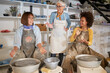 © luckybusiness - Smiling women having fun together making pot in studio on pottery workshop. .  Creative, hobby ,activities concept