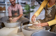 © luckybusiness - Group of People shaping pottery from wet clay. Creative, hobby ,workshop  concept