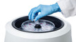 © Justlight - Close up of gloved hand placing a test tube with blue liquid into a laboratory centrifuge, ready for sample preparation and analysis, against a transparent background