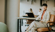 © BGStock72 - Focused professional woman smiles confidently in modern office setup