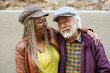 © Sabrina - Happy multiracial senior couple having fun together in the city during travel vacation - Joyful elderly people, lifestyle and urban concept