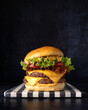 © ADDICTIVE STOCK - Delicious bacon and cheese hamburger with fresh toppings