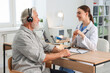 © New Africa - Patient with audiometric headphones undergoing hearing test in clinic