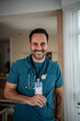 © Migma_Agency - Professional male doctor smiling wearing stethoscope and scrubs