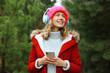 © rohappy - Happy young woman enjoy listening to music with headphones using phone in winter