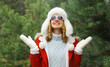 © rohappy - Winter portrait of happy smiling woman having fun enjoys snow against Christmas tree in forest