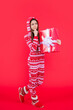 © be free - new year. thinking teen girl with red new year present in studio. teen girl hold new year present
