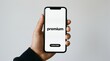 © Norah Allen - Hand holding a smartphone displaying the word 'premium' above a 'subscribe' button on a white screen with a neutral background mobile technology application app digital online membership