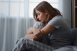 © Pixel-Shot - Sad young woman sitting on sofa at home. International Stress Awareness Week