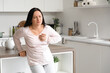 © Pixel-Shot - Young woman having heart attack near table in kitchen