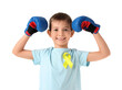 © Pixel-Shot - Cute little happy boy in boxing gloves with yellow ribbon isolated on white background. Childhood cancer awareness concept