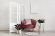 © Pixel-Shot - Cozy chair, folding screen and lilac flowers in vases in living room