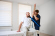 © Василь Івасюк - Chiropractor adjusting male patient’s shoulder in clinic. Physiotherapist performing manual therapy to relieve pain, improve mobility, support rehabilitation after injury or musculoskeletal disorder.