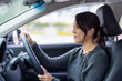 © leungchopan - Woman driving a car on street