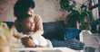 © Ruansan/peopleimages.com - Thinking, couple and hug in lounge, break and bonding on couch with smile, trust and romance in home. Happy, man and embrace with woman in living room, reflection and affection for partner in house