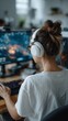 © liliyabatyrova - Focused individual plays an engaging video game in a cozy workspace. Bright screens illuminate the room, showcasing vibrant graphics and animated action