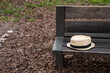 © NadiaA - Straw hipster summer hat on a wooden park bench