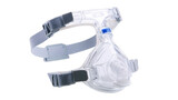 Cpap mask providing continuous positive airway pressure, a common treatment for sleep apnea, features adjustable headgear and a transparent design on a transparent background