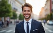 © Abigail - Happy young businessman in the city. Portrait of a smiling Caucasian male in a business suit standing outdoors on a summer day. Handsome European man in a classic suit standing on the street.