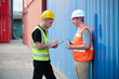 © offsuperphoto - Workers having a conversation in a shipping container