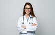 © George - A young female doctor in a white coat and stethoscope, with brown hair and glasses, standing with her arms crossed in a confident pose. High quality