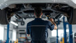 © A2Z AI  - Mechanic inspecting a vehicle's undercarriage with a spotlight. Vehicle service and maintenance in a garage, auto repair shop, or dealership. Professional expertise and care.