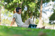 © Laingzaifa - A peaceful young man is relaxing on the lawn, sipping coffee, smiling, listening to music, and conversing calmly. This promotes good health, concentration, peace, happiness, and harmony.