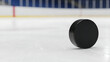 © Lang - Hockey puck background on an ice rink with blank copy space as a winter team sport