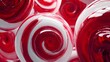 © sungedi - Close-up of a group of vibrant red and white swirled lollipops, delicious and sweet.