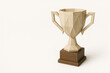 © Andbiz - Origami-style winner's cup on a stand. Space for text.