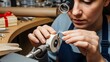 © Mike Ebony - An artisan carefully polishing a piece of metal, using specialized tools and equipment. Her focused expression reveals her dedication to craftsmanship