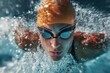 © Iftikhar alam - Female swimmer wearing a hat and goggles trains intensely in the water during a morning practice session for competitive swimming