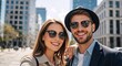 © Vasiliy - A happy young couple taking a selfie in a modern city. Stylish smiling man and woman traveling together on a sunny day outdoors