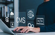 © Supatman - Content management system (CMS) concept. User operating website development tools on laptop, managing web content, cloud data, coding, and multimedia for digital publishing and online presence.