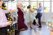 © JackF - Elderly woman dancing energetic twist dance with her partner in studio