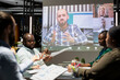 © DC Studio - Enterprise team attend discussion with shareholders on video call, working after hours on establishing clear multinational company objectives. Digital meeting refining the strategy agenda.